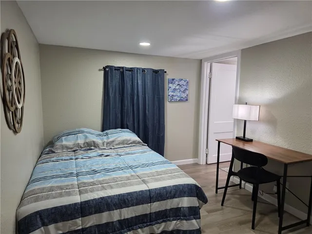 a bedroom with a bed a desk and chair