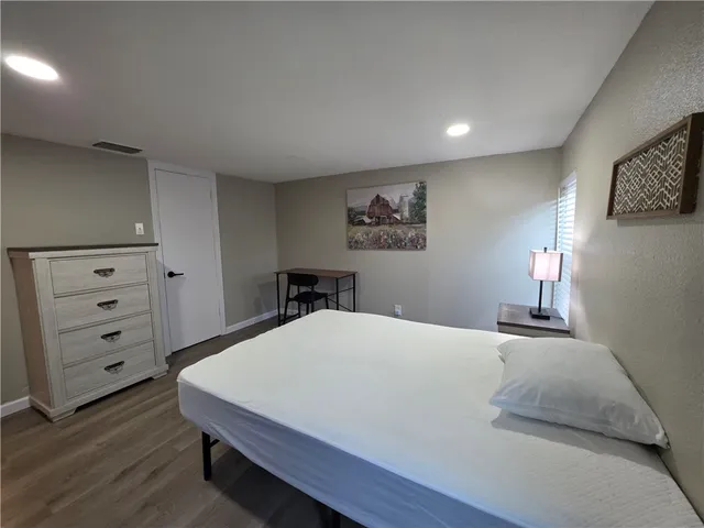 a bedroom with a bed and a dresser