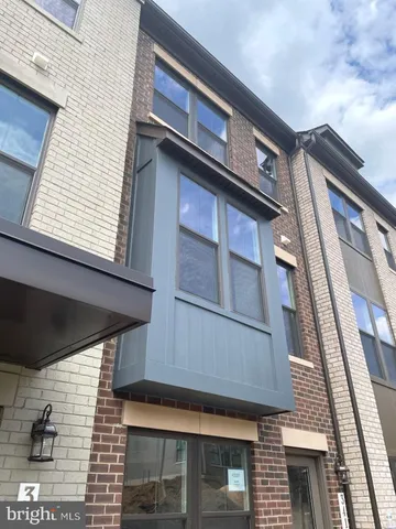 a view of kitchen with refrigerator stove and wooden floor