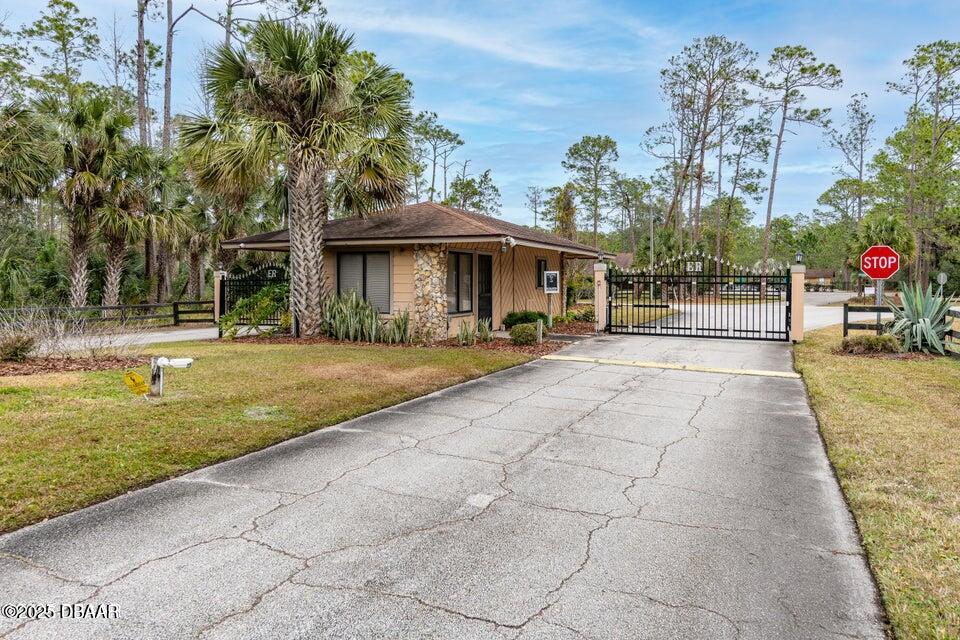 3 Remington Road Ormond Beach, FL 32174 - Photo 6 of 18 a front view of a house with garden