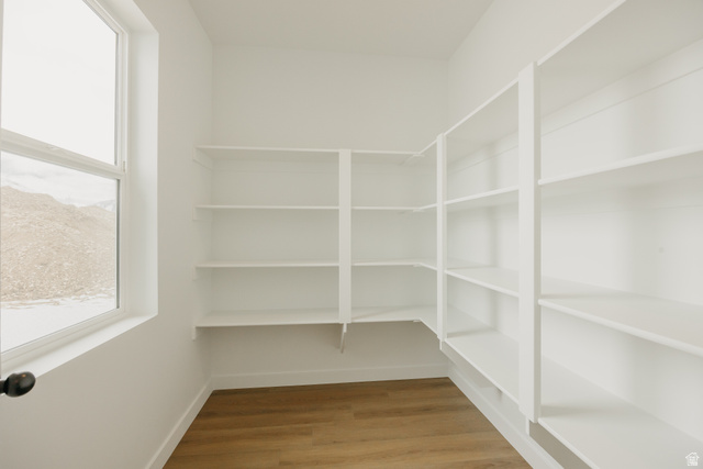 1066n South State Road, Unit ATWOOD Salem, UT 84653 - Photo 21 of 29 Built-in shelving, wood-finish flooring, and a large window