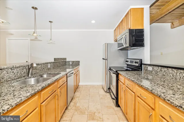 a bathroom with a granite countertop double vanity sink and a mirror