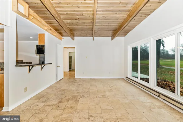 a utility room with wooden floor and white wall
