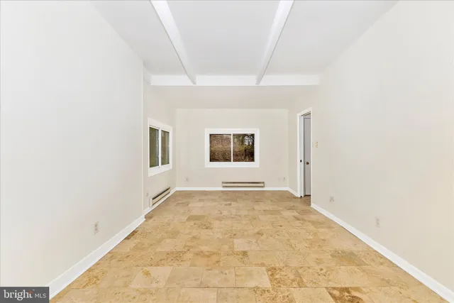 a bathroom with a tub a sink and mirrors