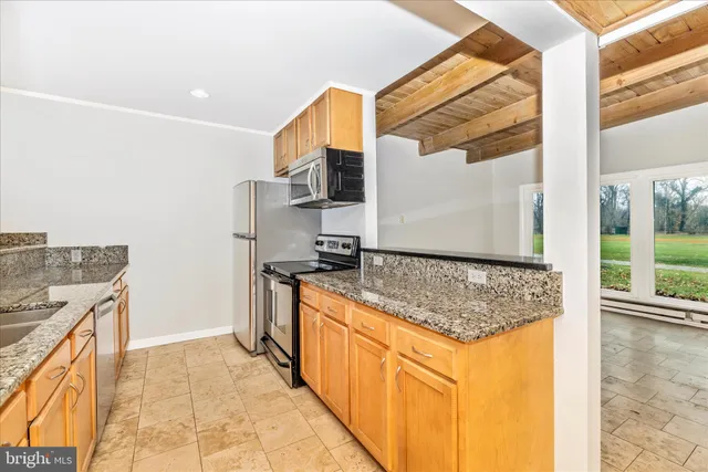 a kitchen with stainless steel appliances granite countertop a stove and a sink