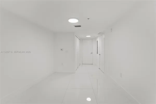a view of an empty room with glass door