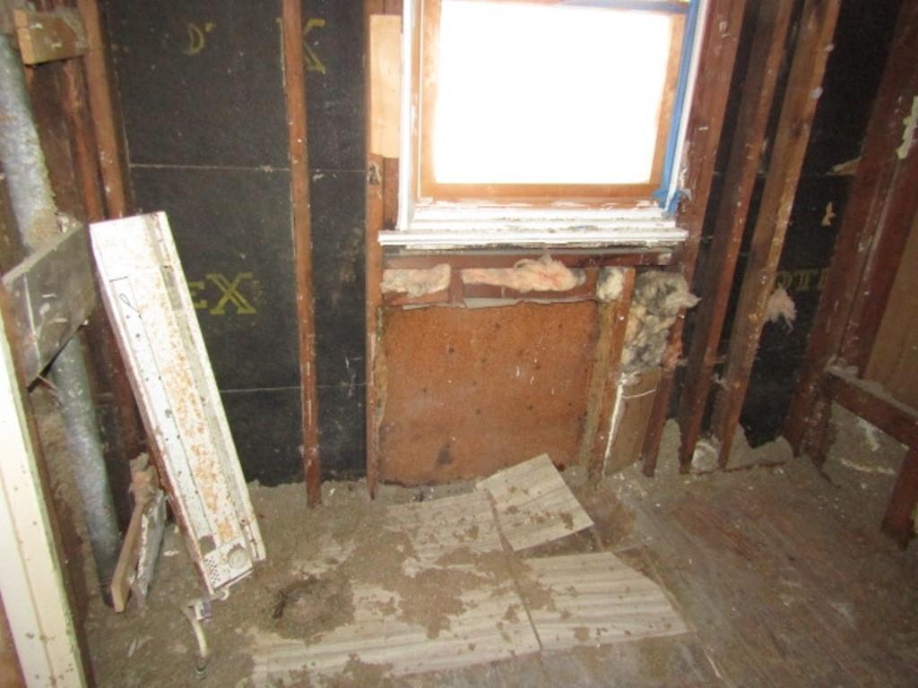 215 Anthony Street Pittsburgh, PA 15210 - Photo 14 of 39 a view of a closet with wooden floor and a chair