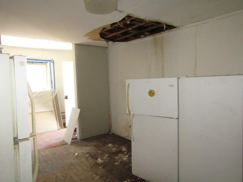 215 Anthony Street Pittsburgh, PA 15210 - Photo 6 of 39 a kitchen with a refrigerator and a stove top oven