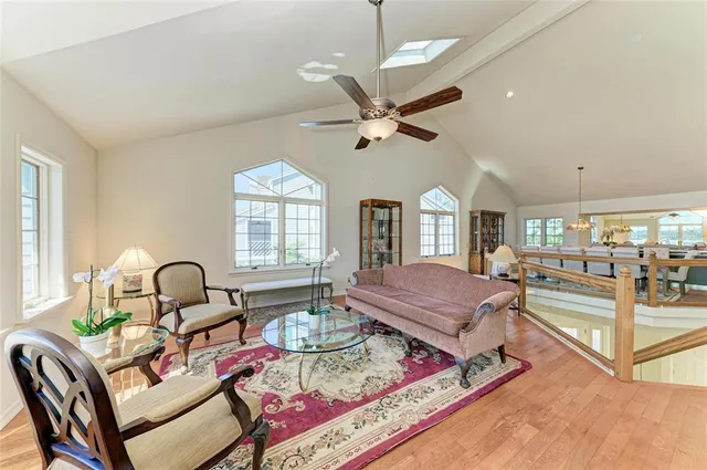 a living room with fireplace furniture and a large window