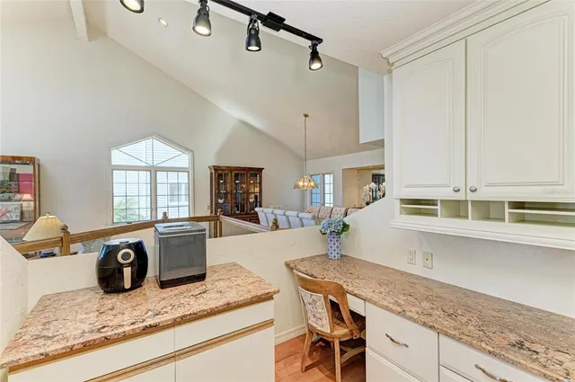 a view of staircase with wooden floor and white walls
