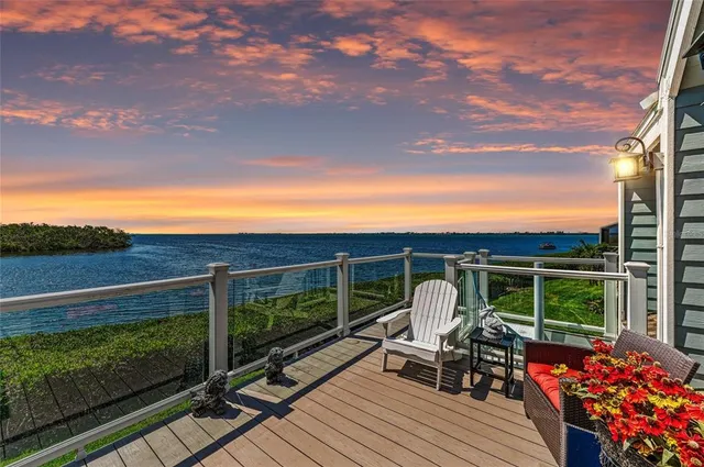 an aerial view of a house with a garden and lake view