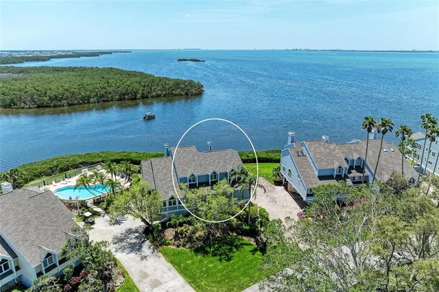 a view of a house with a yard and potted plants