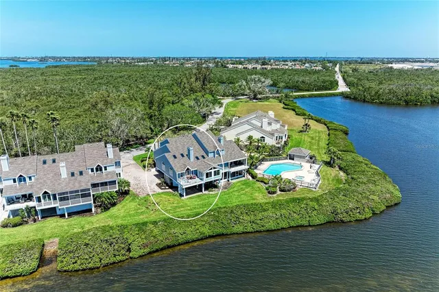 a front view of a house with a yard and potted plants