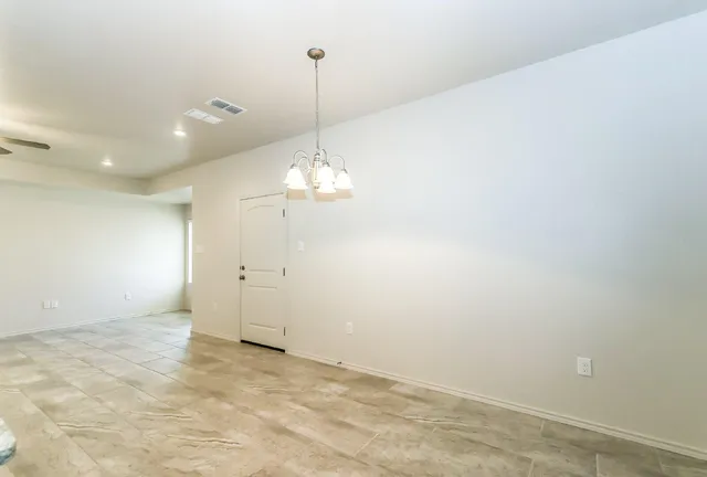 a view of a chandelier fan and entryway