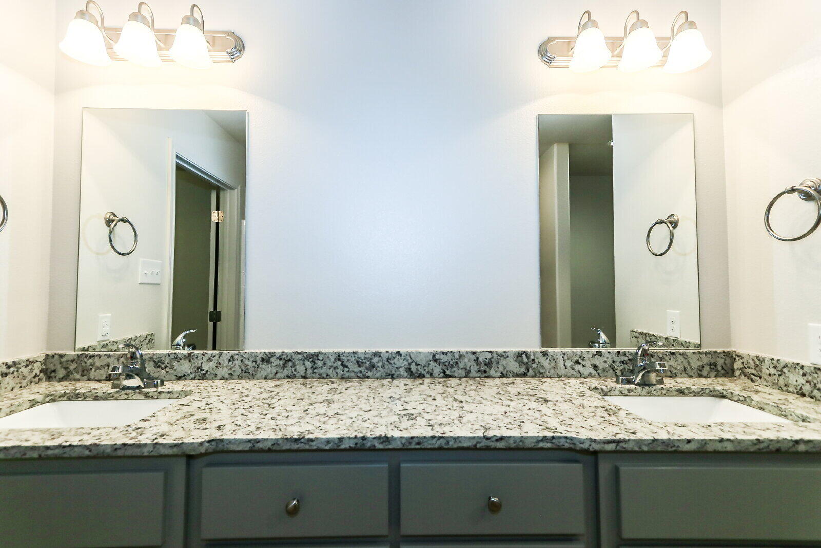 6905 67th Street, Unit B Lubbock, TX 79424 - Photo 23 of 35 a bathroom with a granite countertop sink and a mirror