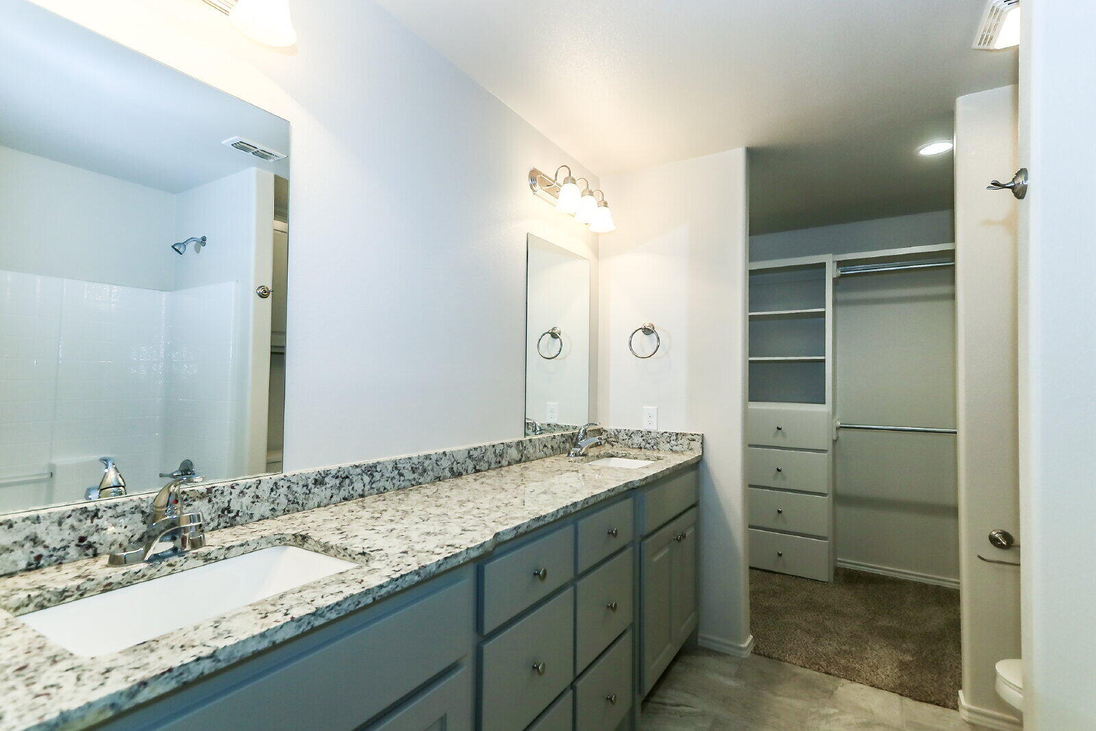 6905 67th Street, Unit B Lubbock, TX 79424 - Photo 24 of 37 a bathroom with a granite countertop sink and a mirror