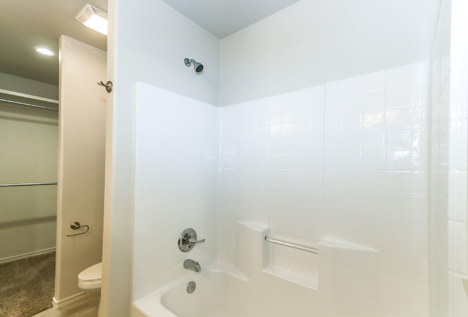 6905 67th Street, Unit B Lubbock, TX 79424 - Photo 25 of 35 a bathroom with a bathtub shower sink vanity and toilet
