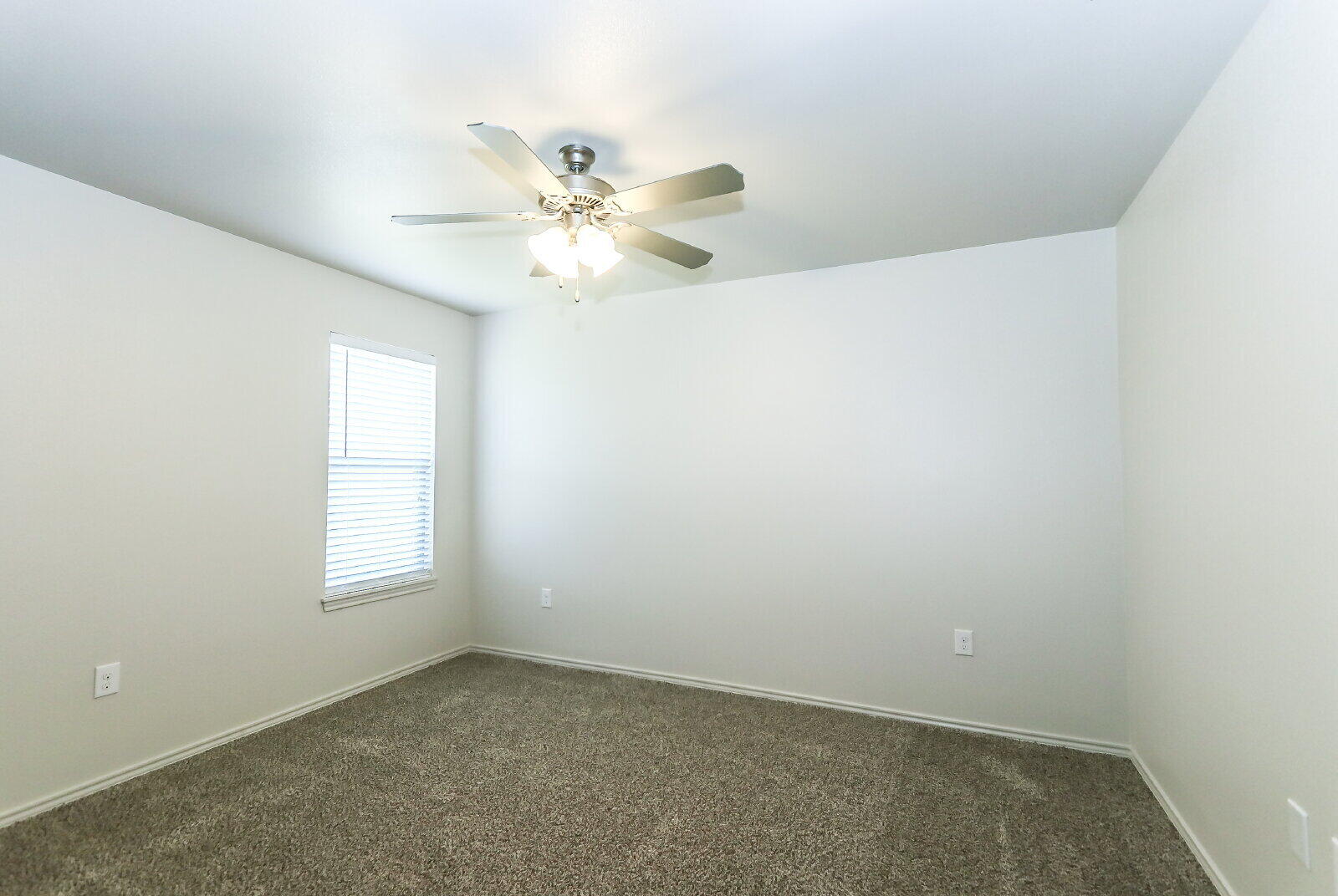 6905 67th Street, Unit B Lubbock, TX 79424 - Photo 30 of 37 an empty room with windows and fan