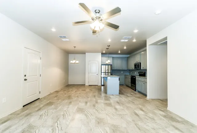 a view of a kitchen with a sink and refrigerator