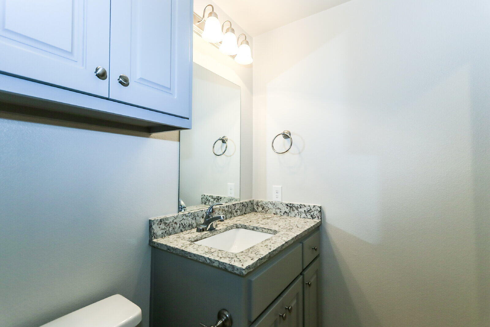 6905 67th Street, Unit B Lubbock, TX 79424 - Photo 34 of 37 a bathroom with a granite countertop sink and a toilet