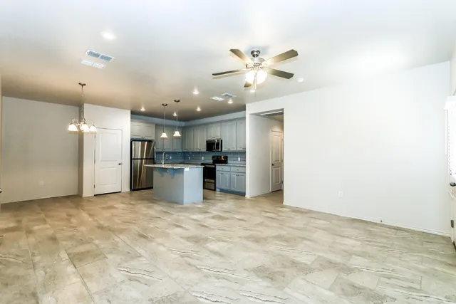a view of a kitchen with a sink and stainless steel appliances
