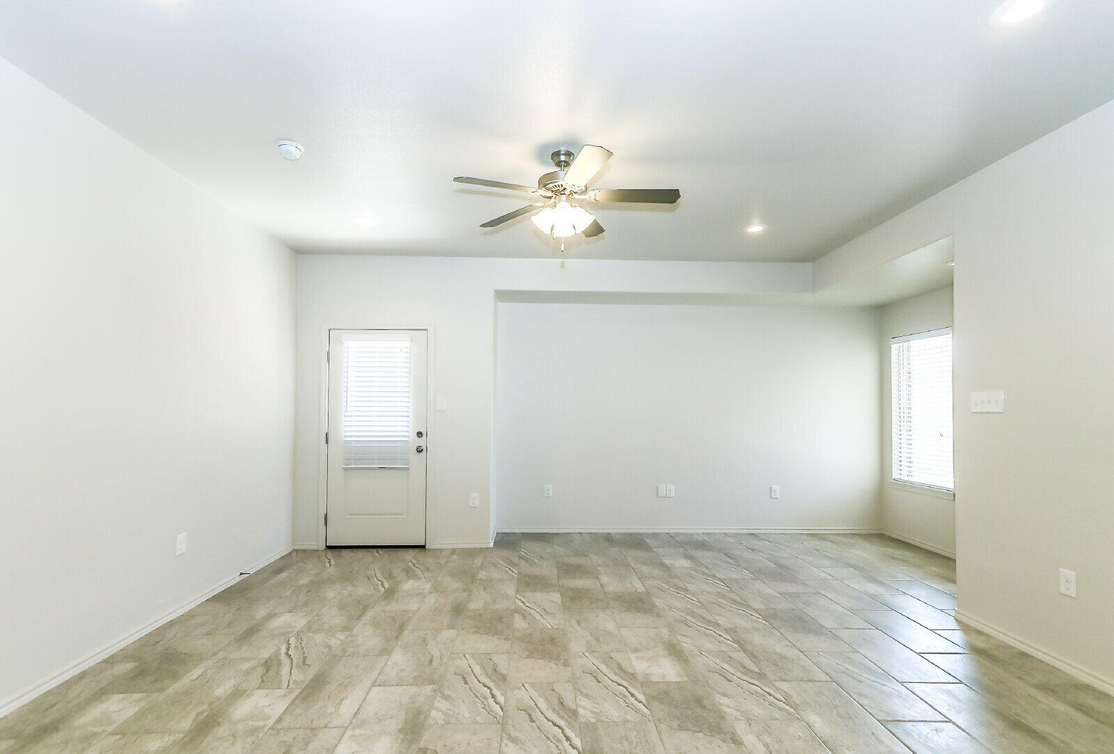6905 67th Street, Unit B Lubbock, TX 79424 - Photo 8 of 37 an empty room with chandelier fan and windows