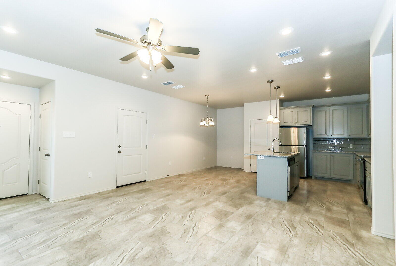 6905 67th Street, Unit B Lubbock, TX 79424 - Photo 8 of 35 a view of a kitchen with a refrigerator and microwave