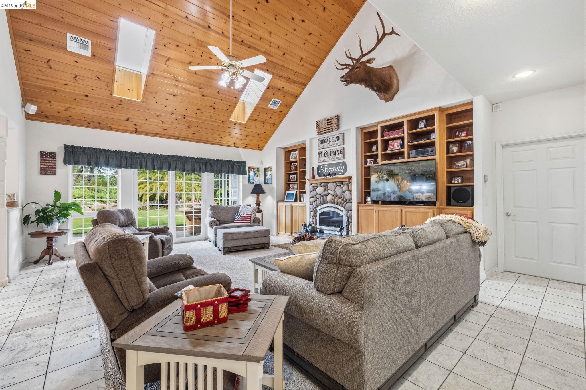 18450 Lambert Lake Road Sonora, CA 95370 - Photo 39 of 87 Vaulted wood-paneled ceiling with skylights and a ceiling fan