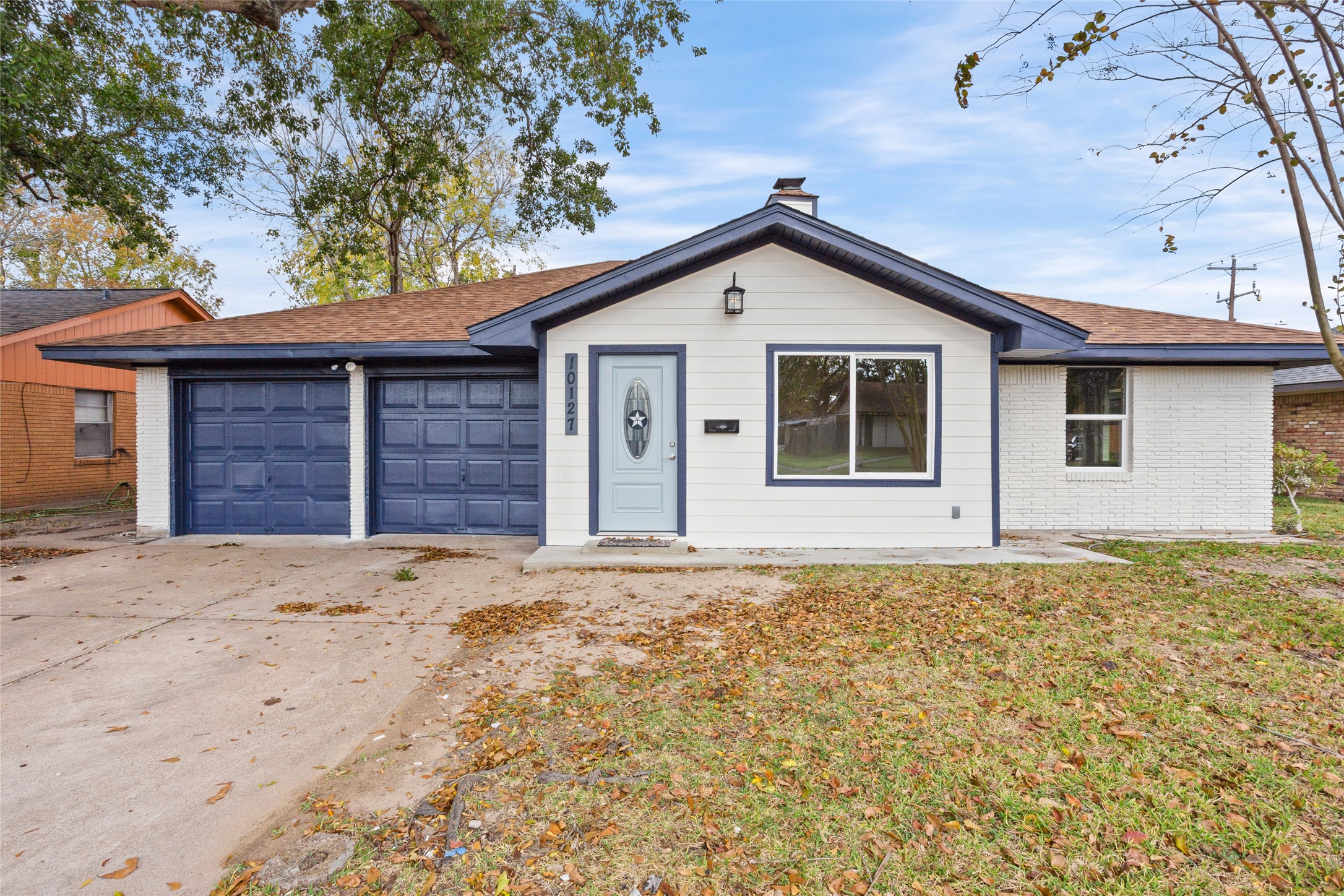 10127 Tolman Street Houston, TX 77034 - Photo 2 of 27 The focal point of the home is the front entrance. It features a powder blue/light blue front door with a decorative oval glass insert containing a star design.
