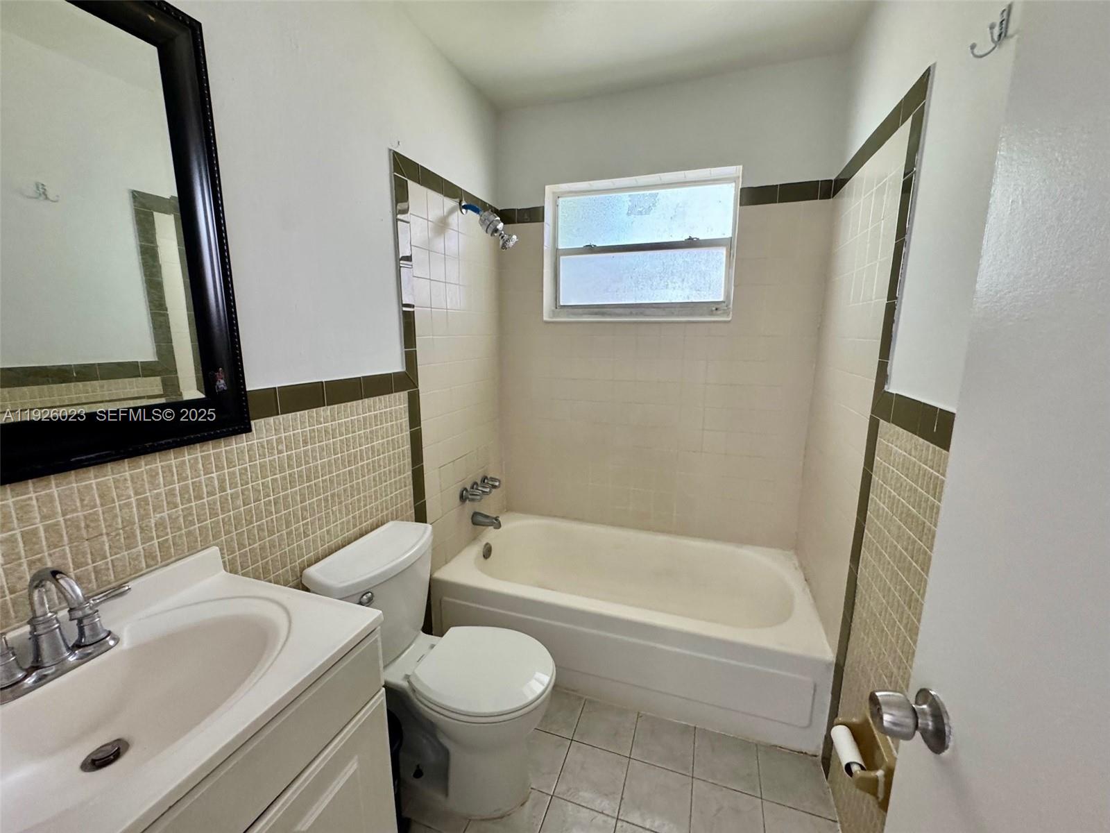 718 Southwest 7th Street, Unit 718 Hallandale Beach, FL 33009 - Photo 12 of 13 a bathroom with a sink toilet and shower