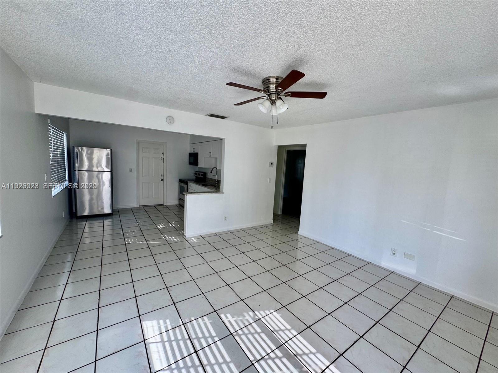 718 Southwest 7th Street, Unit 718 Hallandale Beach, FL 33009 - Photo 9 of 13 a view of an empty room and window