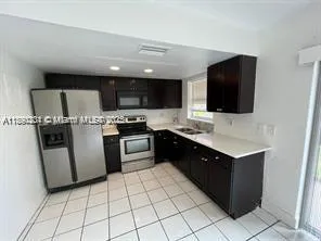 a kitchen with a sink and a stove top oven