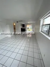 a view of kitchen with granite countertop stove top oven and cabinets