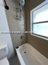 a bath tub sitting next to a white sink