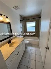 a bathroom with a sink a mirror and a bathtub