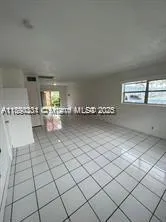 a kitchen with granite countertop a sink and a wooden cabinets