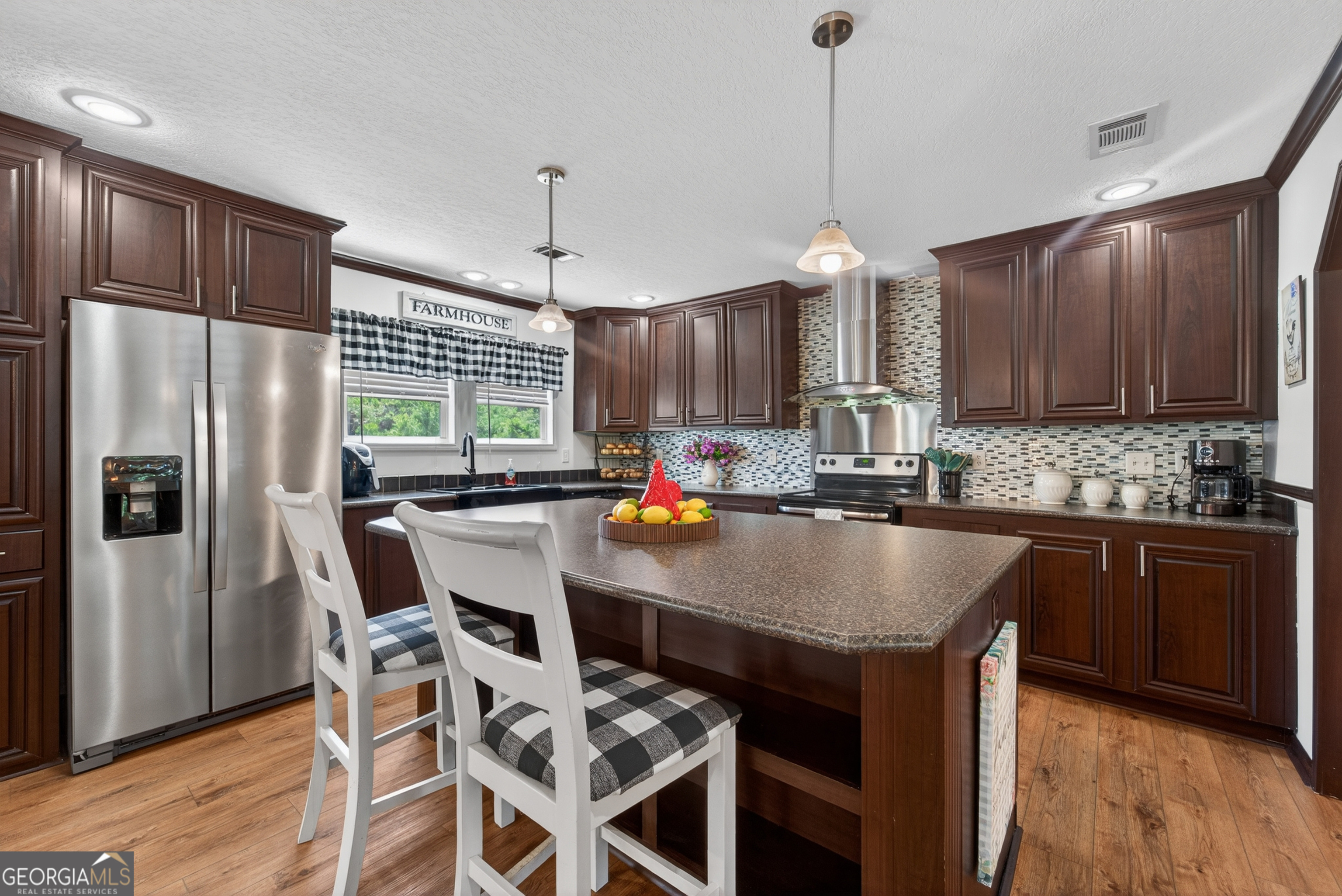 1953 Raybon Road West Hoboken, GA 31542 - Photo 8 of 31 a kitchen with kitchen island granite countertop wooden cabinets and a refrigerator