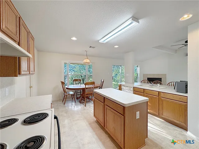 a dining room with furniture a chandelier and wooden floor