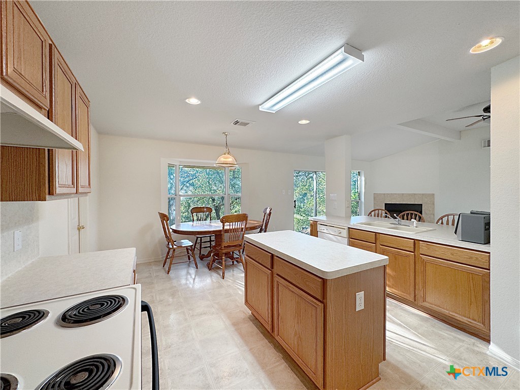 4575 Tanglewood Trail Spring Branch, TX 78070 - Photo 13 of 48 a kitchen with a stove a refrigerator and a dining table
