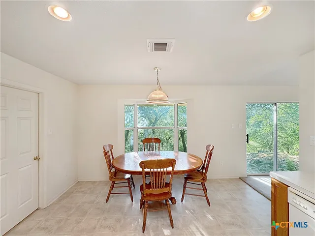 a kitchen with a refrigerator and a stove