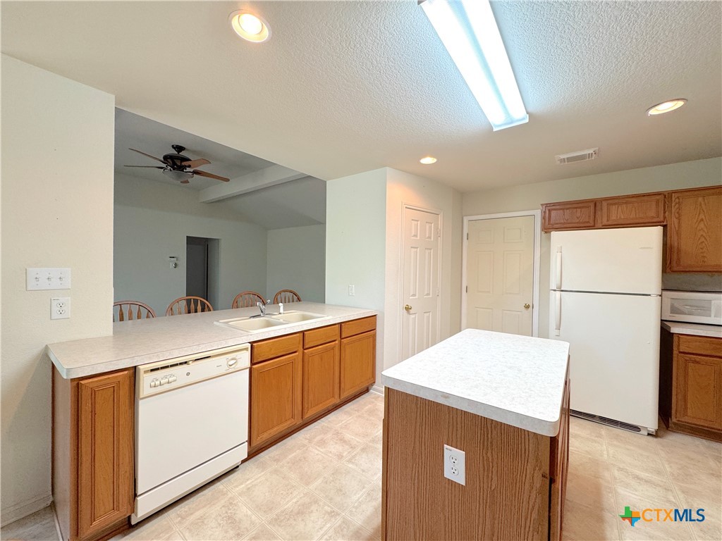 4575 Tanglewood Trail Spring Branch, TX 78070 - Photo 15 of 48 a kitchen with a refrigerator and a stove