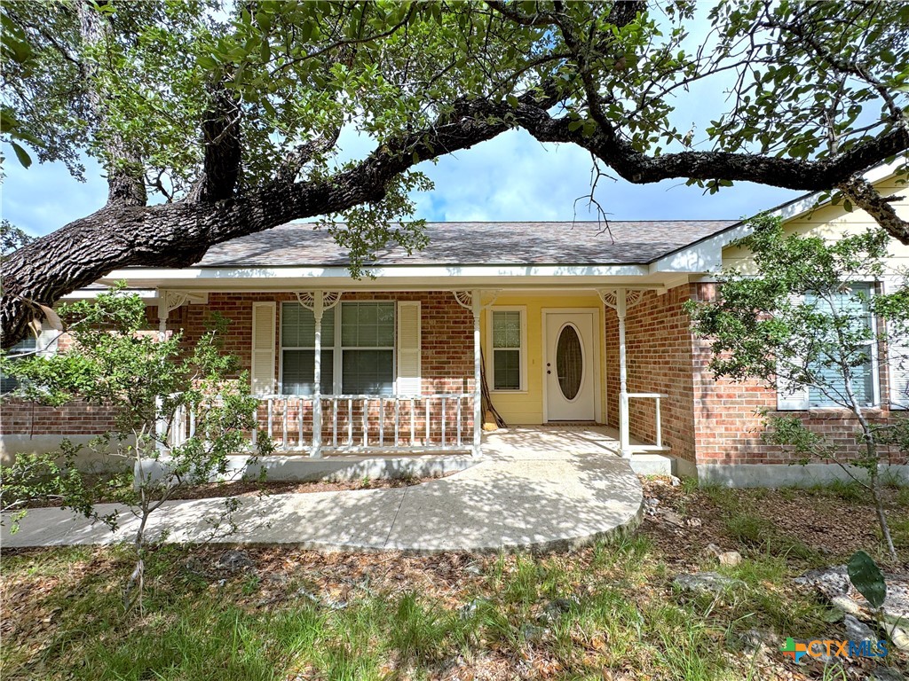 4575 Tanglewood Trail Spring Branch, TX 78070 - Photo 2 of 48 a front view of a house with yard and porch