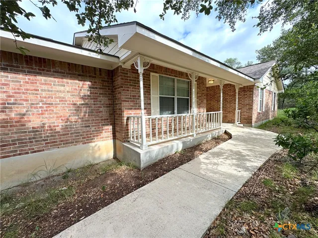 a view of house with backyard and deck