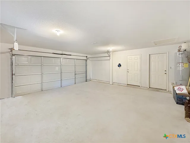 a view of a yard with plants and trees