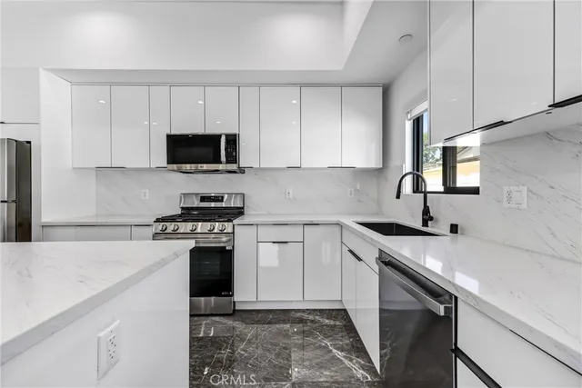 a kitchen with white cabinets