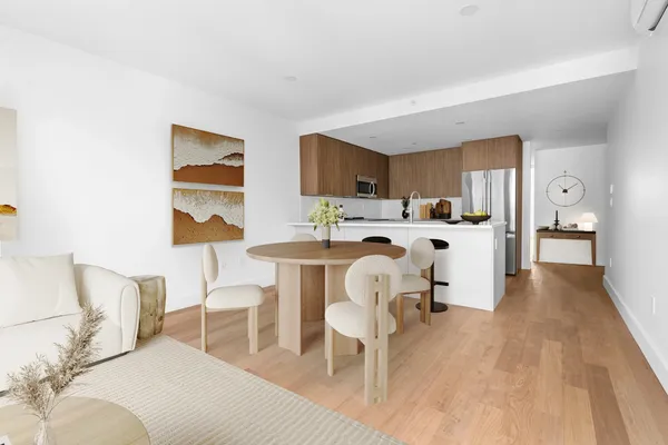 a living room with furniture a dining table and chairs