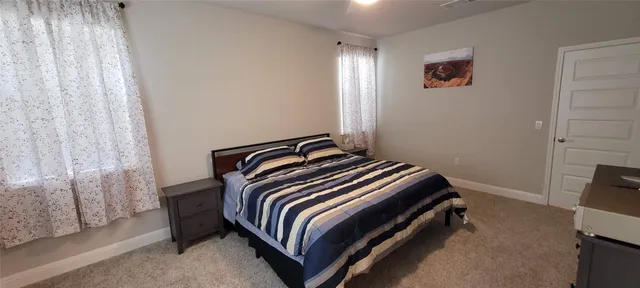 a bedroom with a bed and a tv
