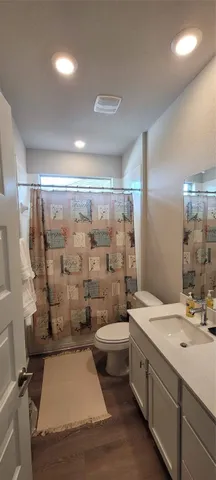 a bathroom with a double vanity sink toilet and shower
