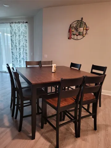 a view of a dining room with furniture and chandelier