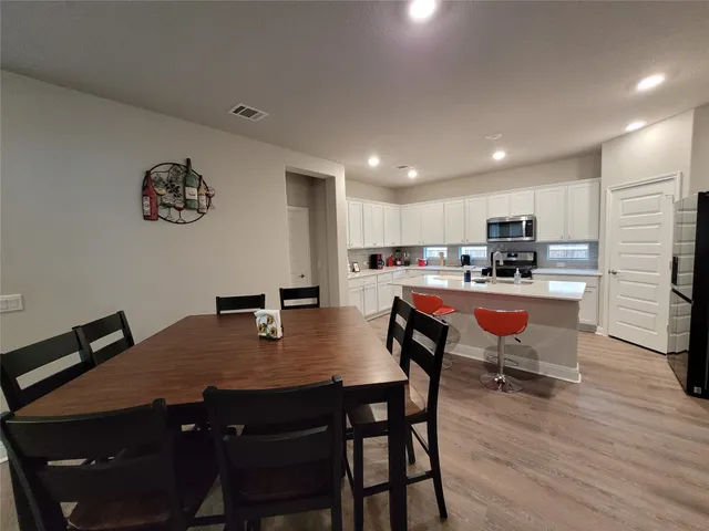 a dining room with kitchen island a table and chairs
